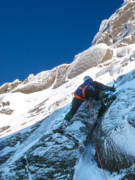 Brian Davison on the technical crux of 101 Dalmatians (VII,7) where precarious moves above the crack lead to an easing in the angle. [And yes, this is a current photo and not a throwback to the 1970s – Brain Davison does still wear a Whillans Harness!] (Photo Andy Nisbet)